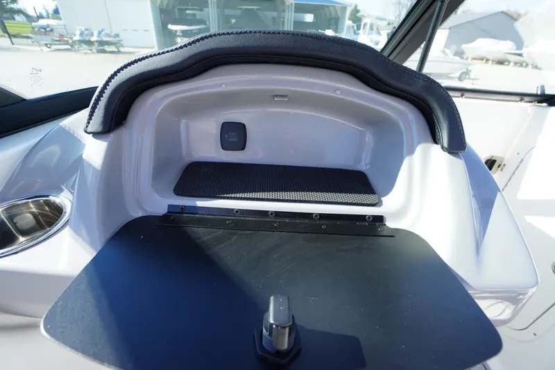 Slide: The Image of 2026 Chaparral 23 SSi OB boat interior storage compartment with cup holder. - 28