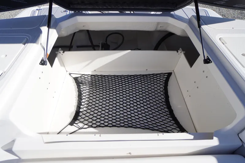 Slide: The Image of Open storage compartment in 2026 Chaparral 23 SSi OB boat with netting. - 55
