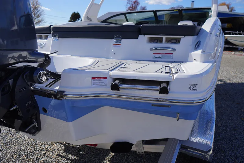 Slide: The Image of 2026 Chaparral 23 SSi OB boat rear view with outboard motor and swim platform. - 64