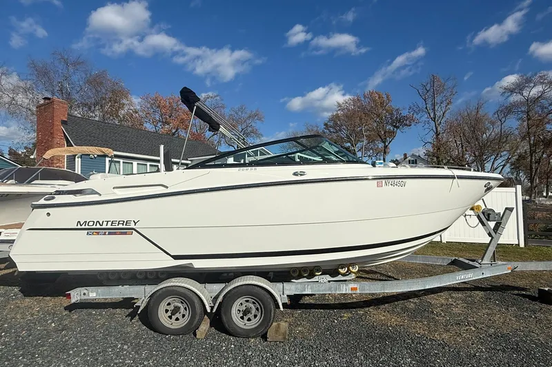 The Image of 2016 Monterey 258SS Super Sport boat on trailer, parked outdoors under blue sky. - 1