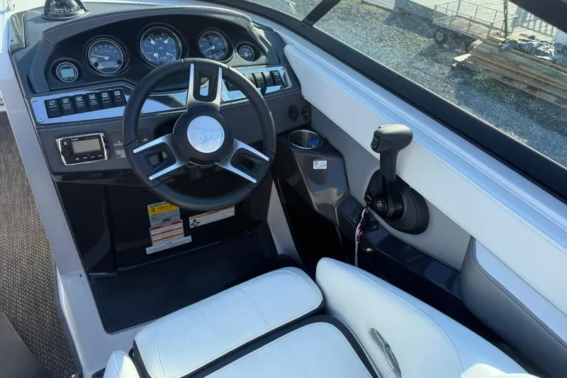 Slide: The Image of 2016 Monterey 258SS Super Sport boat cockpit with steering wheel and controls. - 12