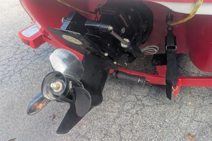 Slide: The Image of 2011 Tahoe Q5L I/O boat propeller and outdrive on a red trailer. - 1