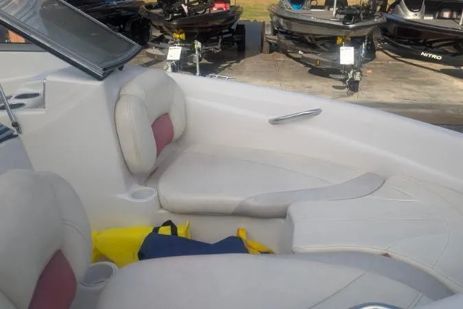 Slide: The Image of 2011 Tahoe Q5L I/O boat interior with white seating and storage area. - 14