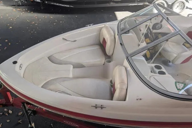 Slide: The Image of 2011 Tahoe Q5L I/O boat interior with white and red seating, under a canopy. - 5