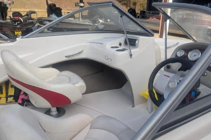 Slide: The Image of 2011 Tahoe Q5L I/O boat interior with white and red seating, steering wheel, and dashboard controls. - 12