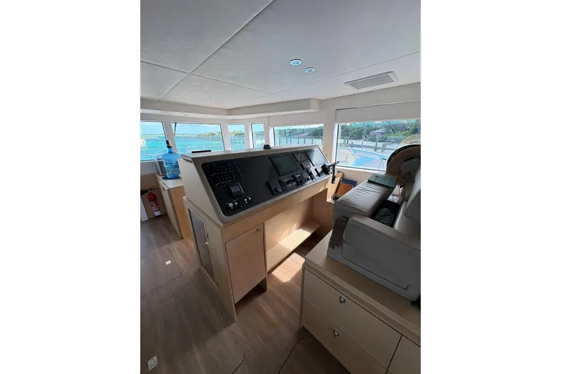 Slide: The Image of Interior of 2020 Silent 55 yacht cockpit with modern navigation controls and panoramic windows. - 16