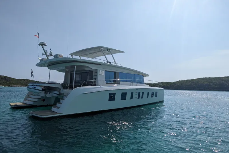 Slide: The Image of Silent 55 yacht from 2020 on calm blue waters, with scenic background. - 5