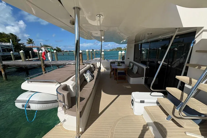 Slide: The Image of Luxurious 2020 Silent 55 yacht deck with seating, table, and scenic waterfront view. - 6