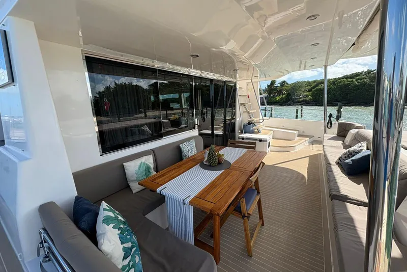 Slide: The Image of Luxurious 2020 Silent 55 yacht deck with elegant seating and dining area by the water. - 7