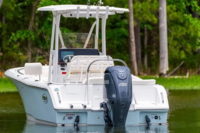 Slide: The Image of 2021 Sea Hunt Ultra 229 boat with Yamaha 200 engine on a calm lake. - 10