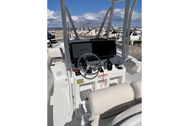 Slide: The Image of 2021 Sea Hunt Ultra 229 boat dashboard with Garmin display at marina. - 2