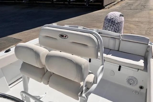 Slide: The Image of 2021 Sea Hunt Ultra 229 boat interior with cushioned seating and steering console. - 8