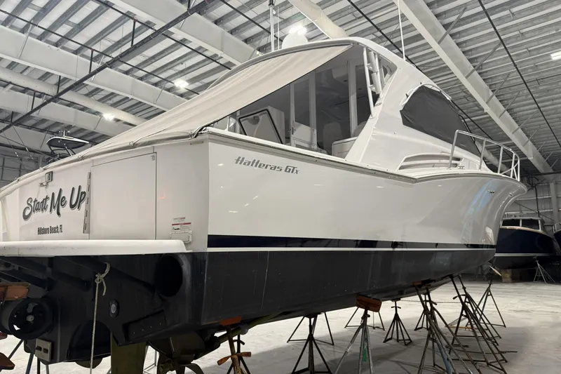 Slide: The Image of 2020 Hatteras GT45X yacht in a boatyard, elevated on stands. - 16