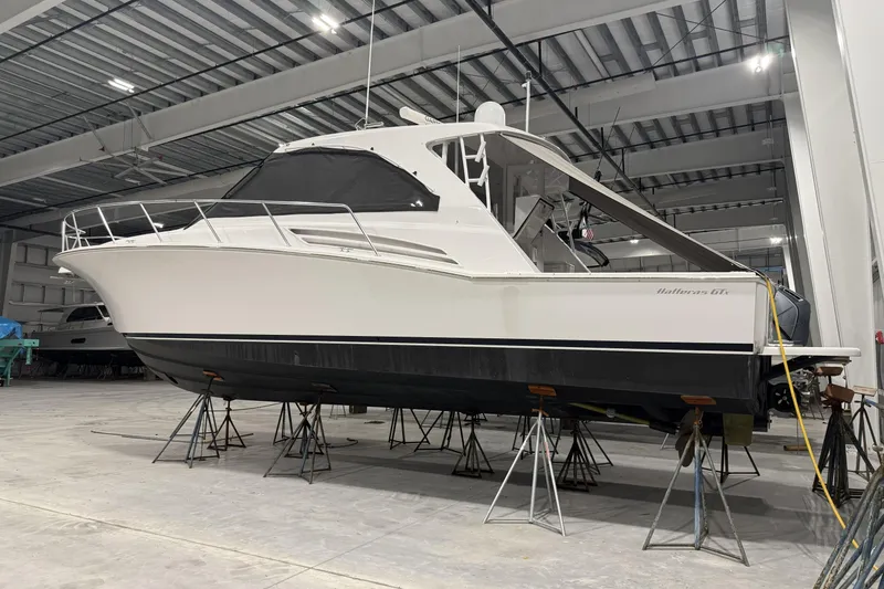 Slide: The Image of 2020 Hatteras GT45X yacht in a storage facility, elevated on stands. - 18
