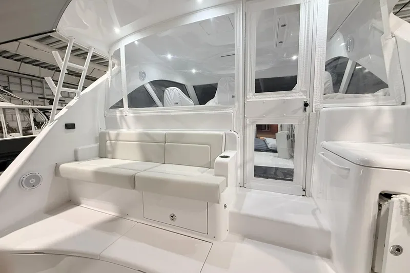 Slide: The Image of 2020 Hatteras GT45X yacht interior with white seating and modern design. - 19