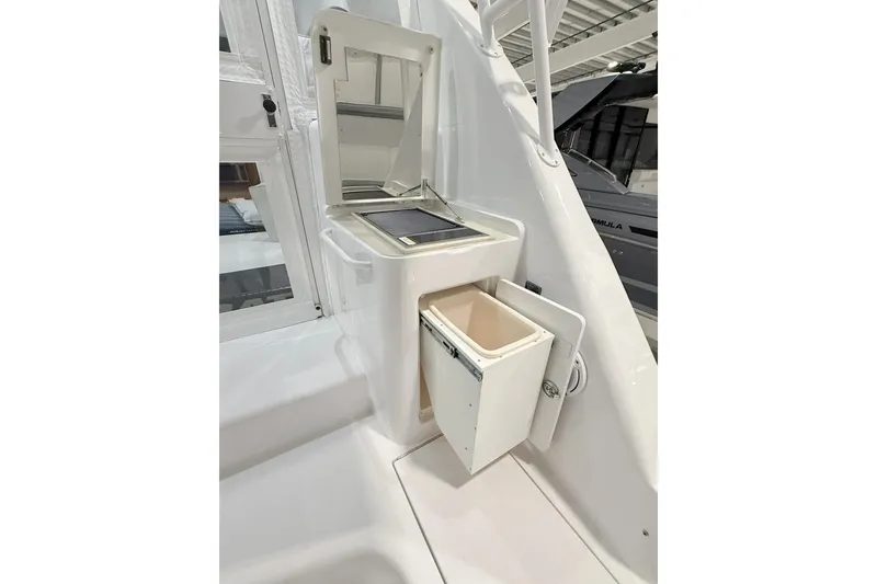 Slide: The Image of 2020 Hatteras GT45X boat interior with storage compartment and trash bin. - 20