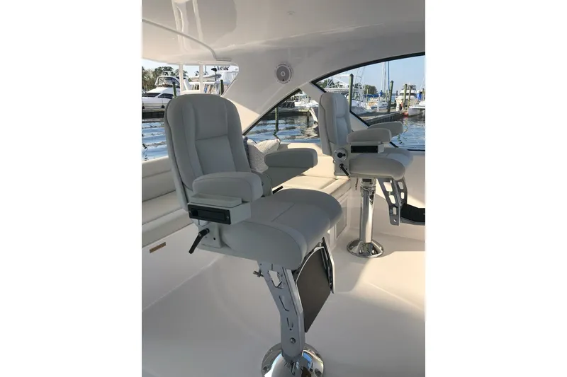 Slide: The Image of 2020 Hatteras GT45X yacht interior with luxurious seating and marina view. - 27