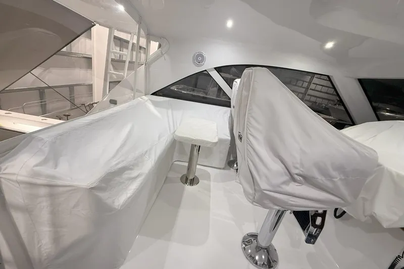 Slide: The Image of 2020 Hatteras GT45X yacht interior with covered seating and helm, showcasing modern design. - 28