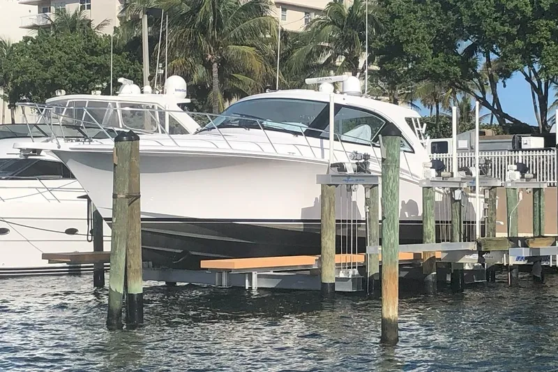 Slide: The Image of 2020 Hatteras GT45X yacht docked at marina with palm trees in background. - 3