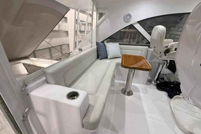 Slide: The Image of 2020 Hatteras GT45X yacht interior with white seating and wooden table. - 31