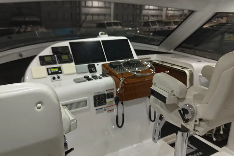 Slide: The Image of Helm of 2020 Hatteras GT45X yacht with advanced navigation controls and seating. - 36