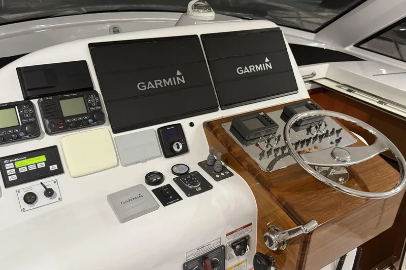 Slide: The Image of 2020 Hatteras GT45X helm with Garmin navigation systems and control panel. - 38