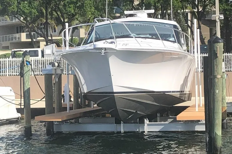 Slide: The Image of 2020 Hatteras GT45X yacht docked on a lift, front view. - 4