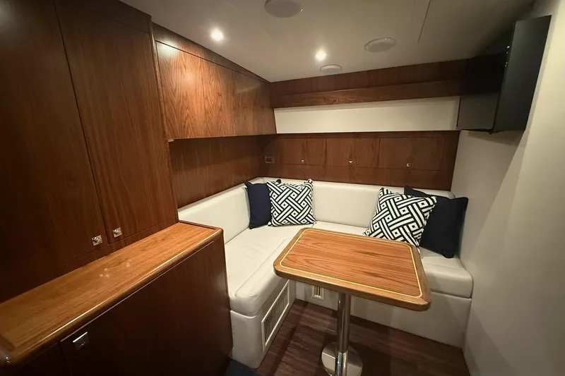 Slide: The Image of Luxurious interior of 2020 Hatteras GT45X yacht with wood cabinetry and cozy seating area. - 46