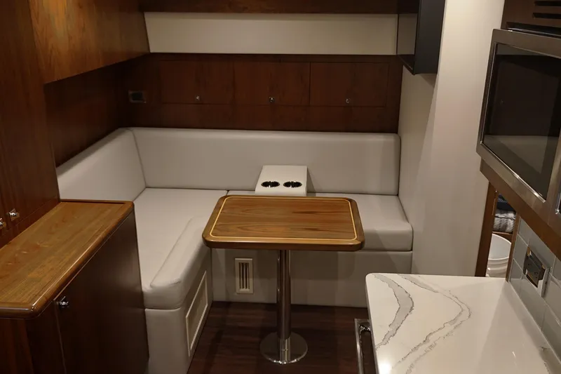 Slide: The Image of 2020 Hatteras GT45X yacht interior with cozy seating and modern kitchenette. - 47
