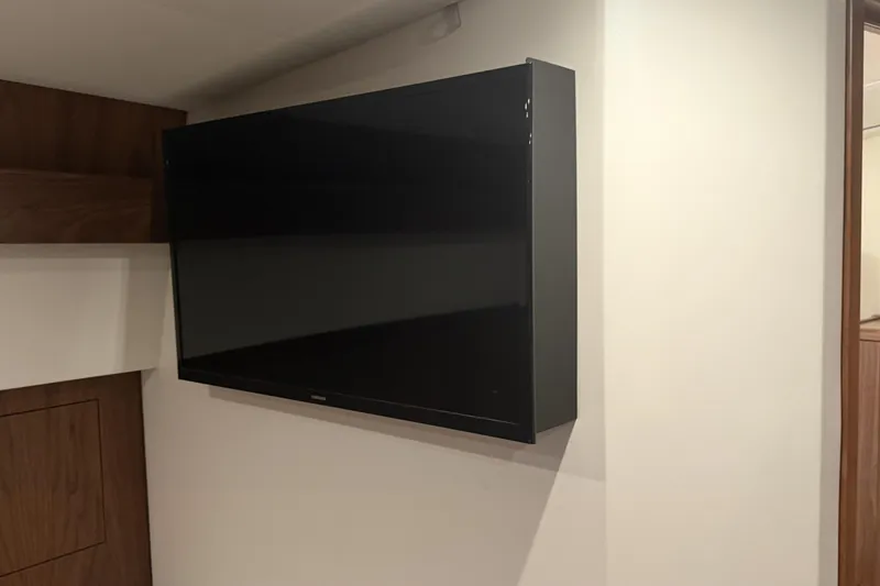 Slide: The Image of Wall-mounted TV inside 2020 Hatteras GT45X yacht interior, featuring modern design elements. - 48