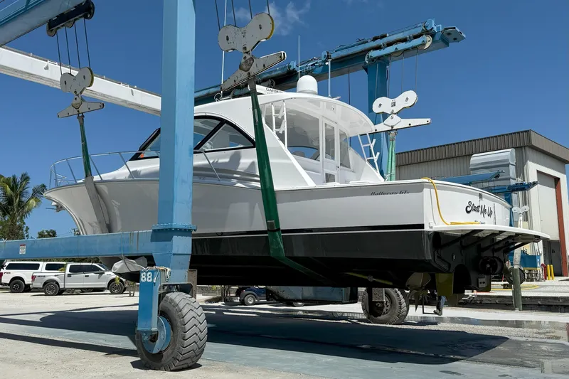 Slide: The Image of 2020 Hatteras GT45X yacht in dry dock, suspended by a blue crane. - 5
