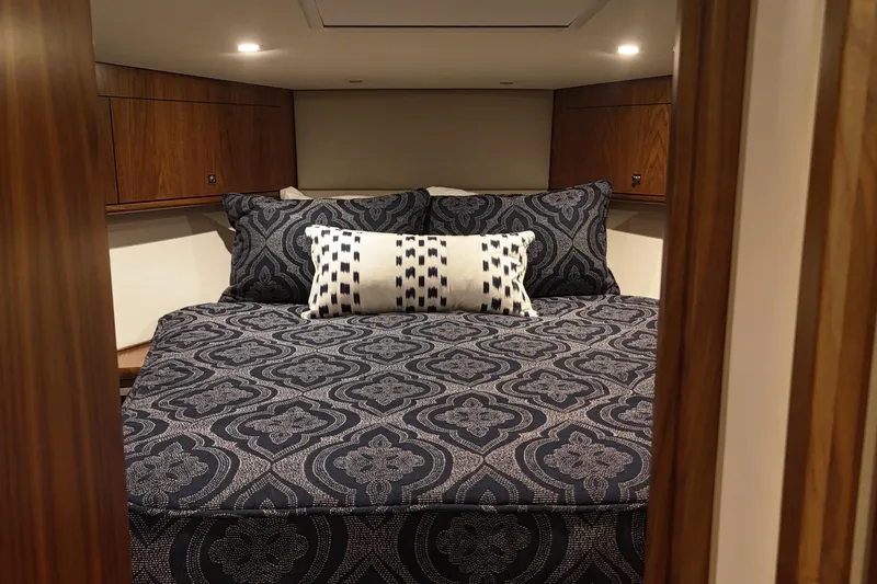 Slide: The Image of Luxurious cabin interior of 2020 Hatteras GT45X yacht with patterned bedding. - 52