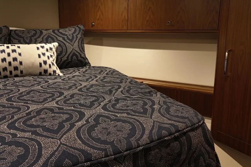 Slide: The Image of Luxurious cabin interior of 2020 Hatteras GT45X yacht with patterned bedding. - 53