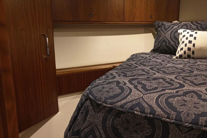 Slide: The Image of Luxurious cabin interior of 2020 Hatteras GT45X yacht with patterned bedding. - 54