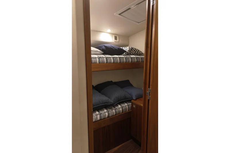 Slide: The Image of 2020 Hatteras GT45X yacht interior with cozy bunk beds and wooden finish. - 55