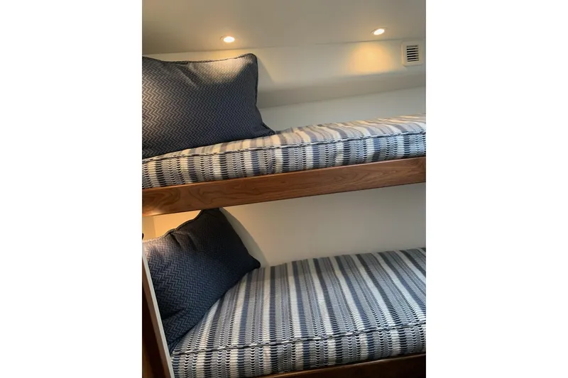 Slide: The Image of Bunk beds with blue patterned bedding in 2020 Hatteras GT45X yacht cabin. - 56