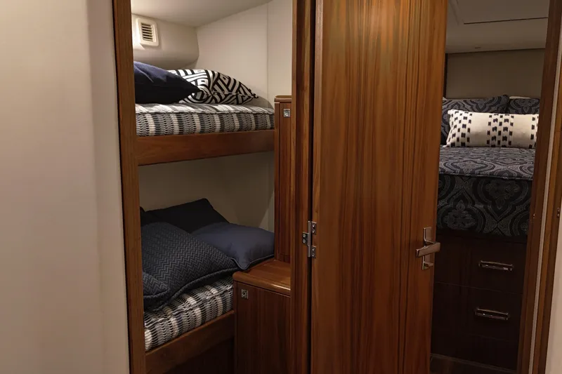Slide: The Image of Interior of 2020 Hatteras GT45X yacht with cozy bunk beds and elegant wood finish. - 58