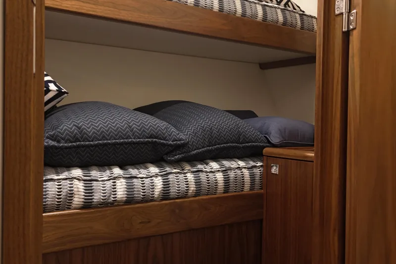 Slide: The Image of 2020 Hatteras GT45X yacht interior with cozy bunk beds and stylish bedding. - 59