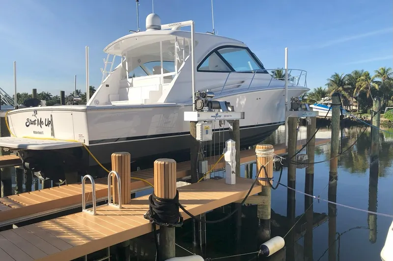 Slide: The Image of 2020 Hatteras GT45X yacht docked at marina with clear blue sky. - 6