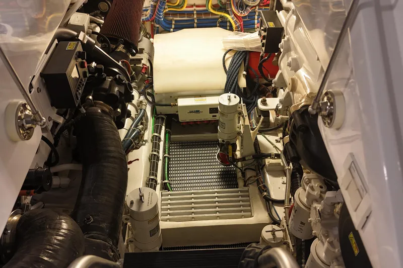 Slide: The Image of Engine room of 2020 Hatteras GT45X yacht, showcasing complex machinery and wiring. - 65
