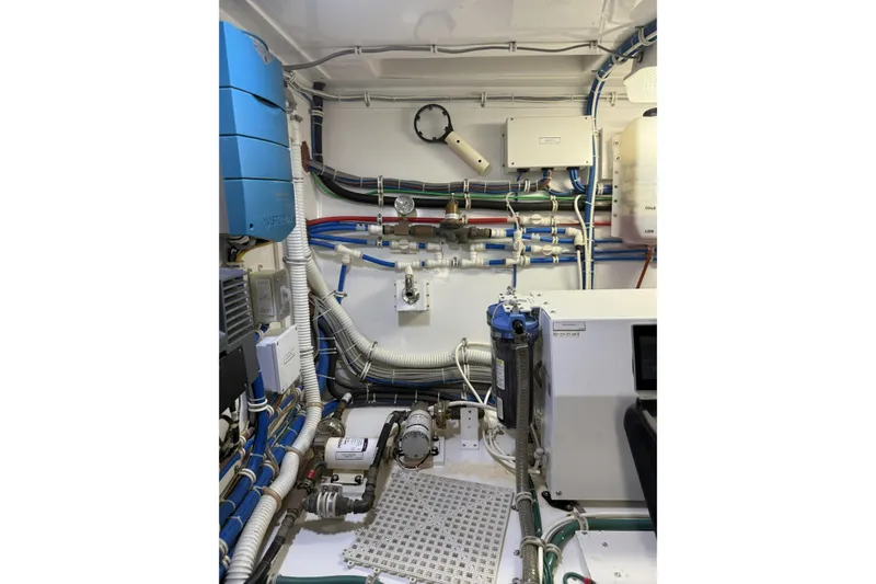 Slide: The Image of Engine room of 2020 Hatteras GT45X yacht, showcasing complex wiring and equipment. - 67