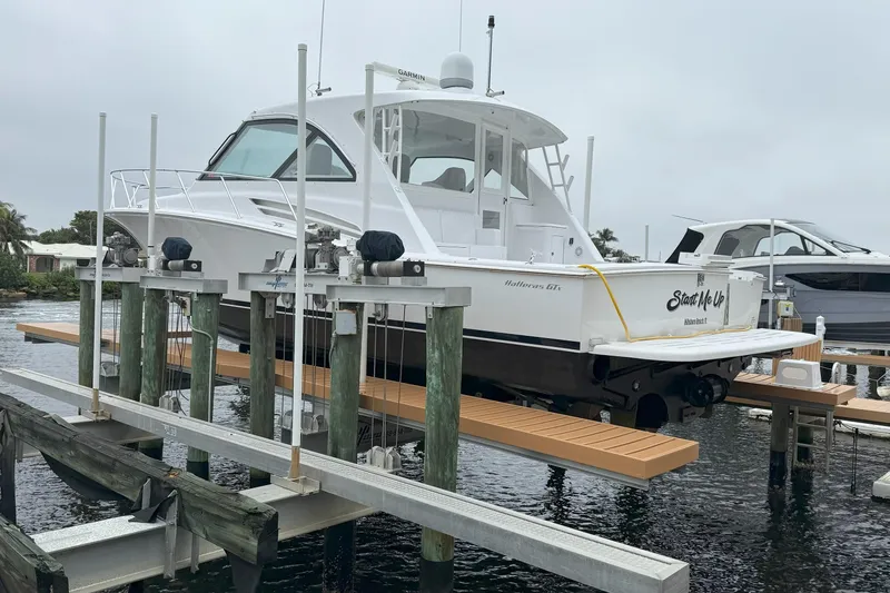 Slide: The Image of 2020 Hatteras GT45X yacht on lift at marina, overcast day. - 7