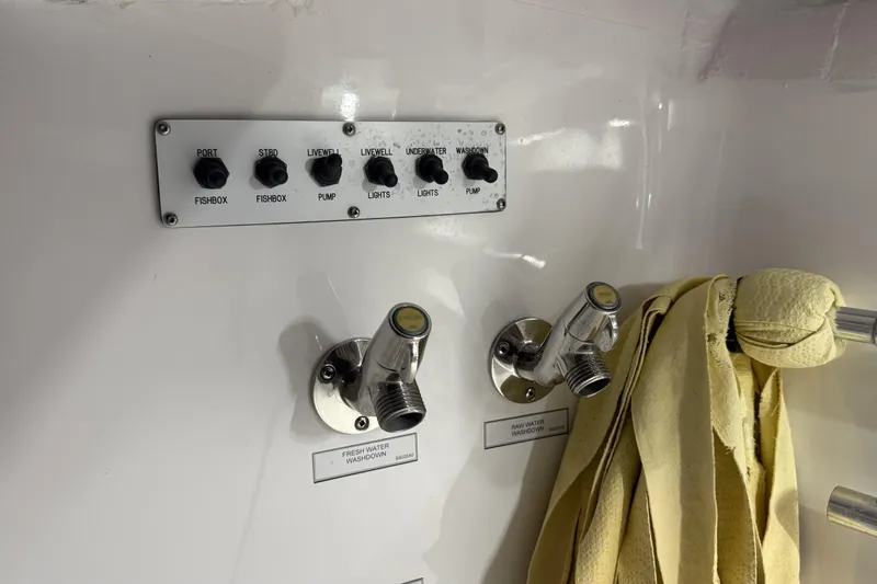 Slide: The Image of Control panel and washdown faucets on a 2020 Hatteras GT45X boat. - 75