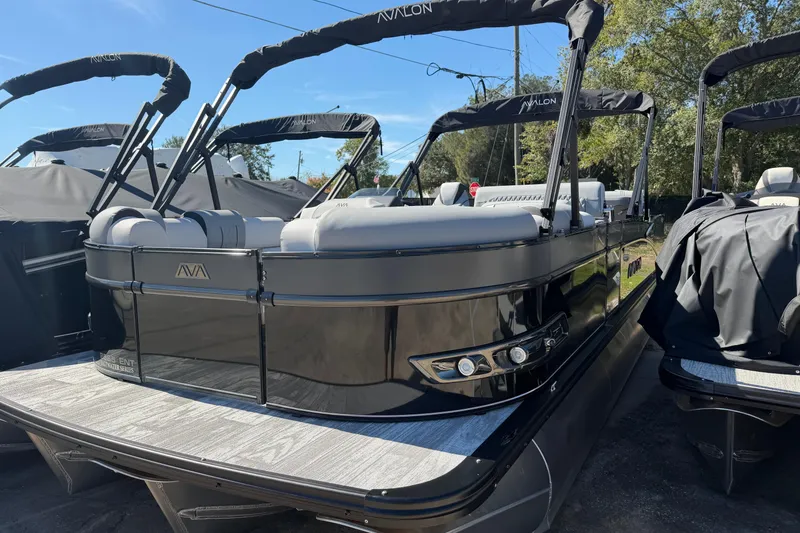 The Image of 2026 Avalon Catalina Entertainer pontoon boat with sleek black design and comfortable seating. - 1