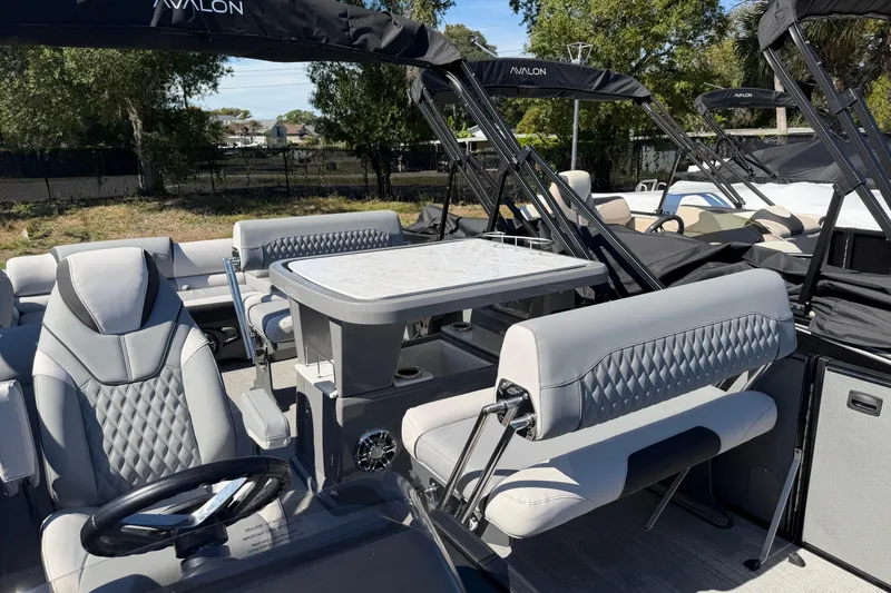 Slide: The Image of 2026 Avalon Catalina Entertainer boat interior with luxurious seating and table setup. - 3