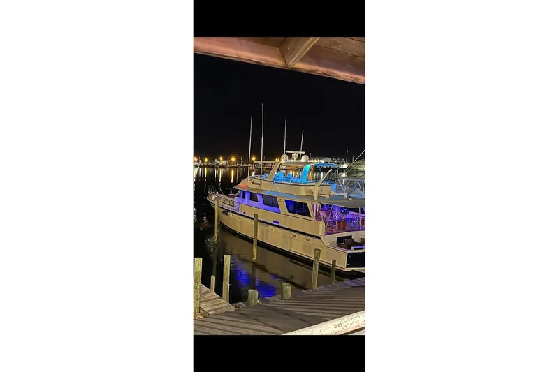 Slide: The Image of 1984 Hatteras 61 Cockpit MY with striped seating and teak deck flooring. - 22