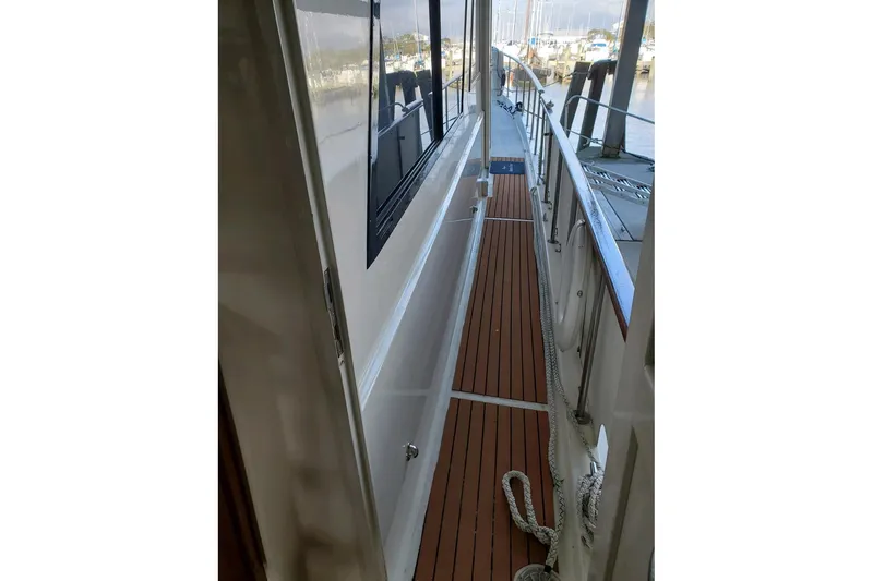 Slide: The Image of 1984 Hatteras 61 Cockpit MY cabin with bunk beds and colorful pillows. - 28