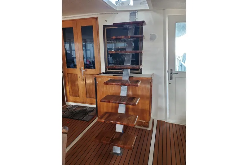 Slide: The Image of 1984 Hatteras 61 Cockpit MY yacht side deck with wooden flooring and railing. - 29