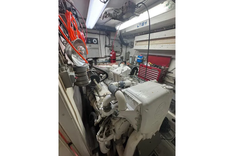 Slide: The Image of Engine room of 1984 Hatteras 61 Cockpit MY with visible machinery and tools. - 52