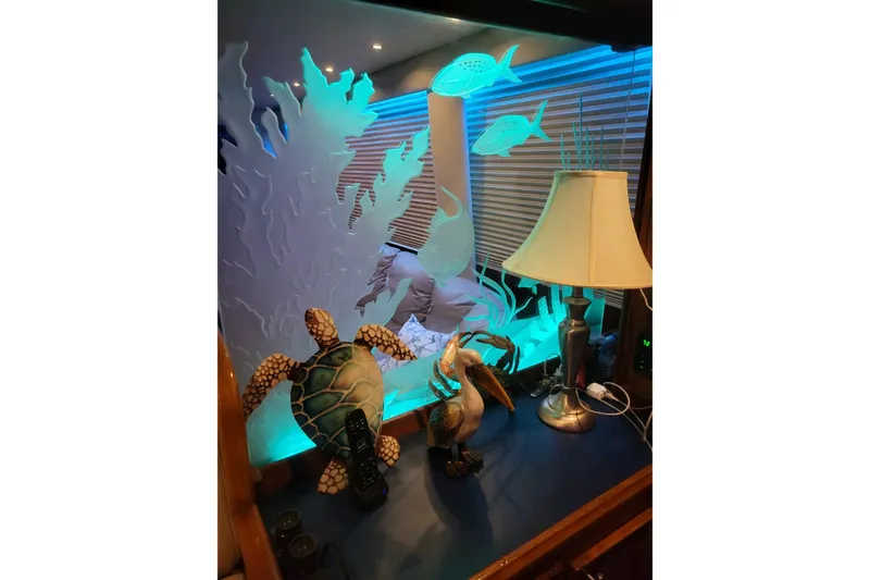 Slide: The Image of Luxurious interior of 1984 Hatteras 61 Cockpit MY yacht with aquarium and plush seating. - 38